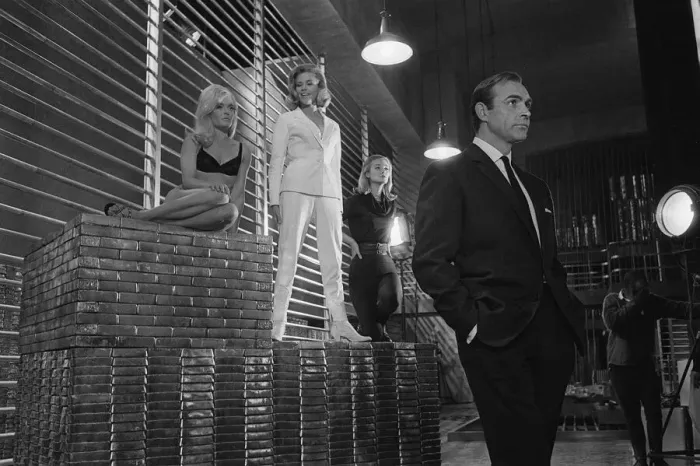 Framed Print : Film Goldfinger 1964 Sean Connery as James Bond 007 poses with Bond girls Honor Blackman