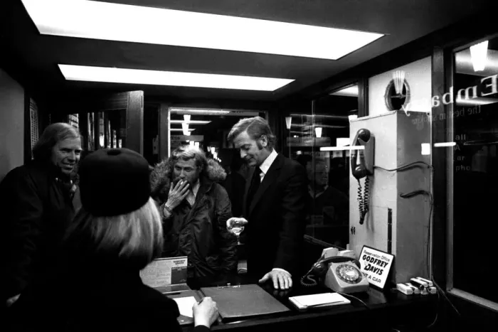Framed Print : Film legend Michael Caine off-camera with a glass of wine in Godrey Davies car hire