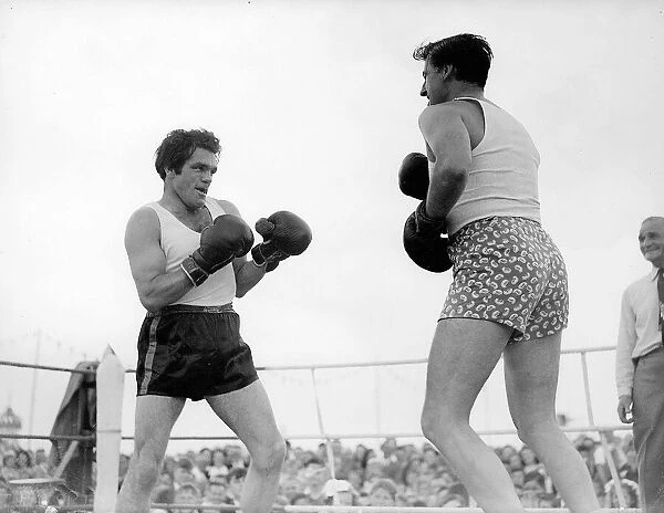 Film star Stewart Granger spars with Freddie Mills at the Ford Families Gala