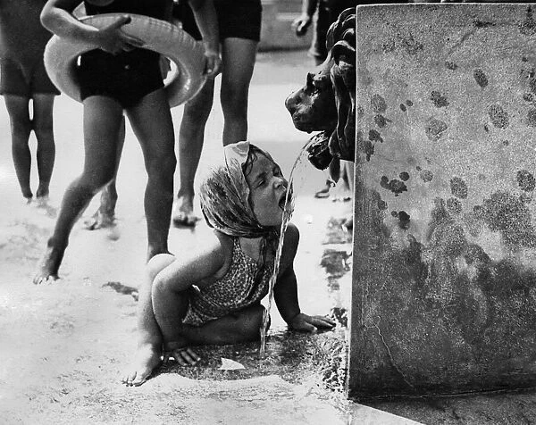 Finchley Swimming Pool. Straight from the lions mouth this little girl cools down