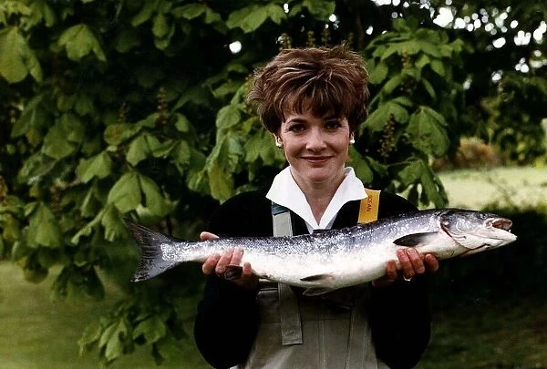 Fiona Armstrong ITN TV Presenter and News reader holding a fish May 1991