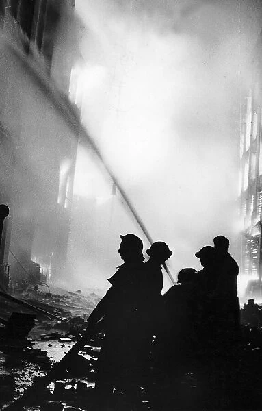 Fire fighters tackle a blaze in a London street. Y2K WW2 On the night of 29