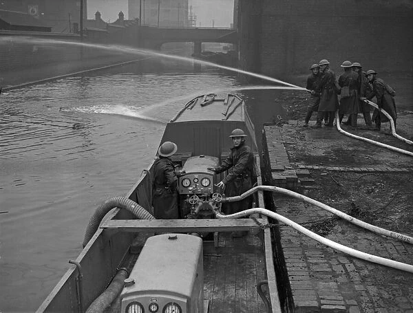 Fire Float Practice. Members of the Birmingham Auxiliary Fire Service Naval Detachment