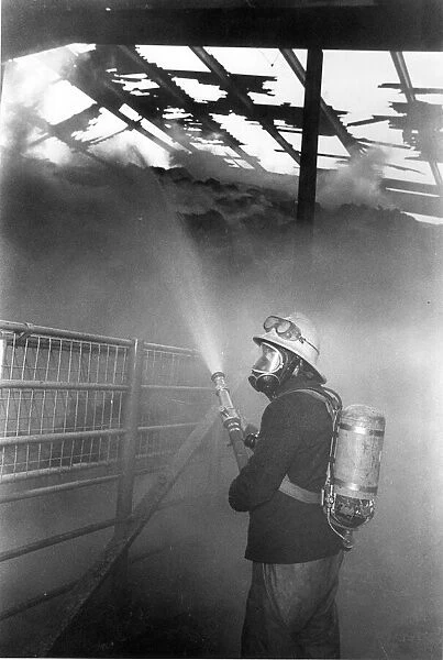 A firefighter fights the flames at a blaze at Hexham Auction Mart