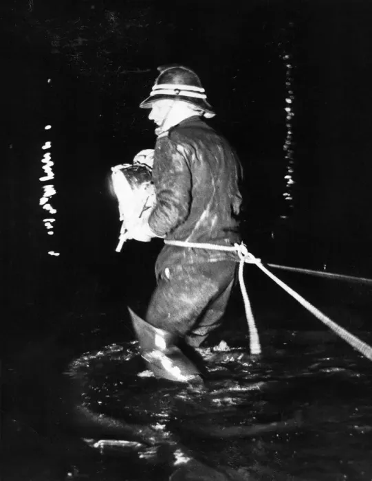 Framed Print : A firefighter scans the water looking for the stolen car which was driven into the river Framed Print : A firefighter scans the water looking for the stolen car which was driven into the river