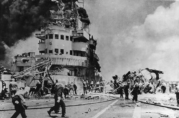 Firefighters busy on board HMS Formidable after a Japanese suicide plane had crashed