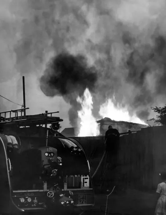 Framed Print : Firefighters contain a fire at a double-decker bus used as a storehouse at Washington