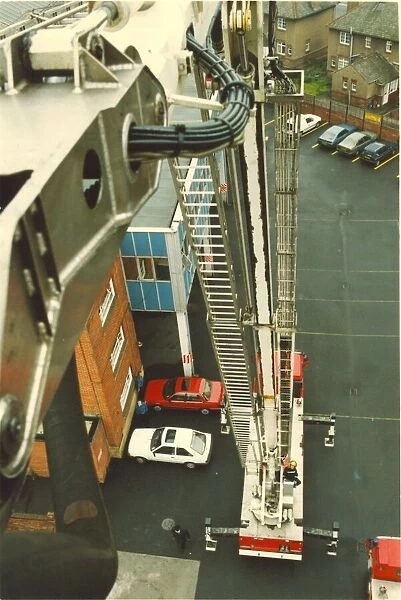Firefighters practice rescue routines using one of their turntable ladders at