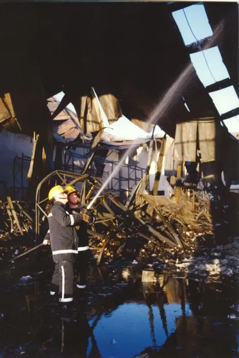 Framed Print : Firefighters get the warehouse fire under control