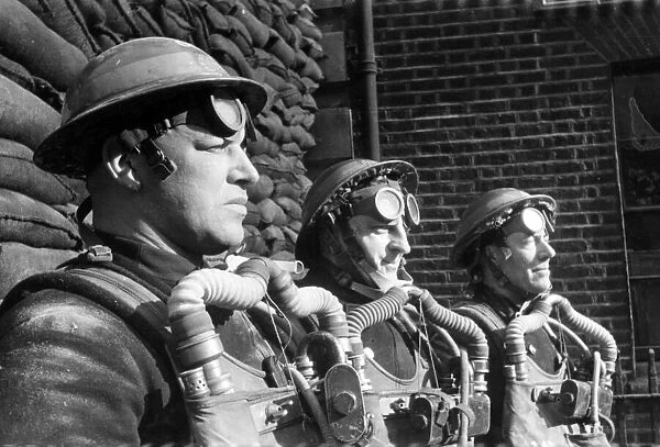 Firefighters wearing breathing apparatus during a training exercise. Circa 1940