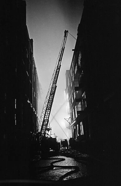 Firemen attempt to control fires in Shoreditch, London, during an air raid on the city