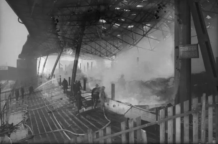 Framed Print : Firemen dampen down the burnt-out shell of the grandstand at St Framed Print : Firemen dampen down the burnt-out shell of the grandstand at St