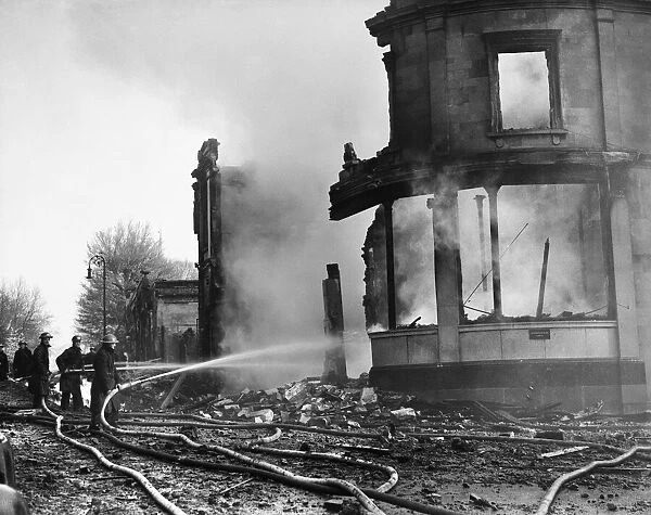 Firemen dampen down the fires caused by a a Luftwaffe attack on the City of Bristol