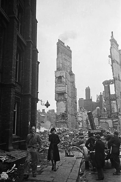 Firemen dampening down the smouldering ruins in the the City of London following