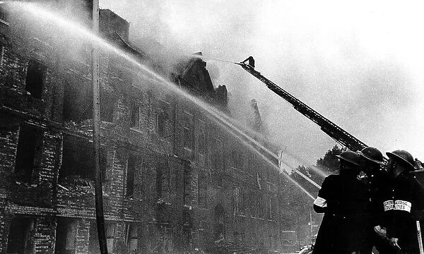 Firemen fight a fire in Camberwell New Road London after a German flying bomb attack