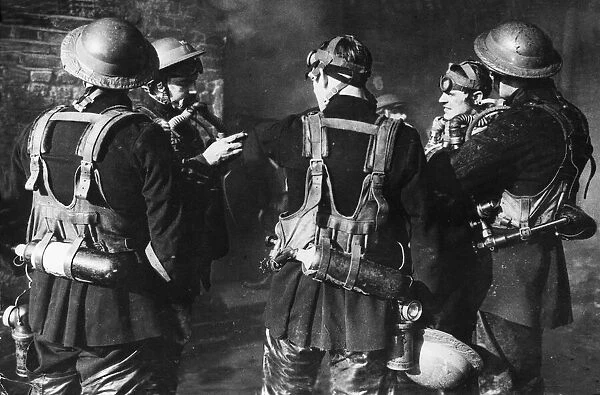 Firemen The London Fire Brigade. Checking their oxygen masks during the Blitz