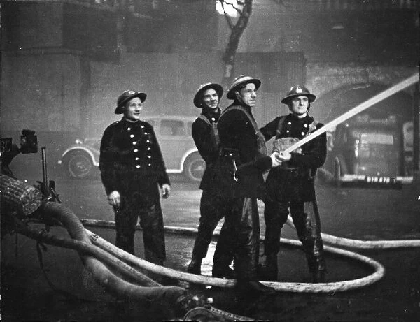 Firemen The London Fire Brigade, after successfully putting out a South East London fire