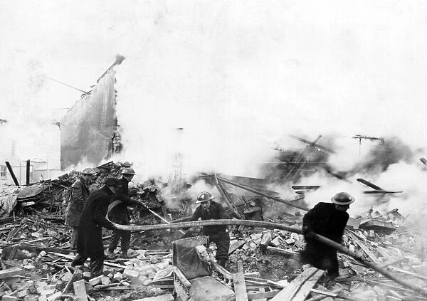 Firemen tackle blazing ruins at Llanbleddian Gardens, Cardiff, following air-raid attacks