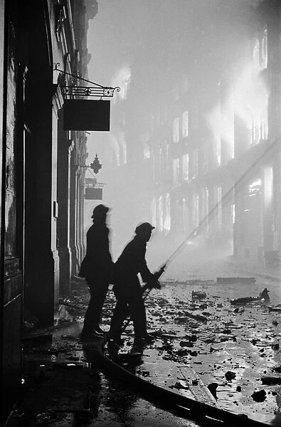 Firemen at work on Ave Maria Lane on the night of 29th December 1940