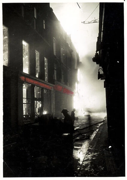 Fires blazing in a shopping district of London MOI Dated 17th April 1941 *** Local