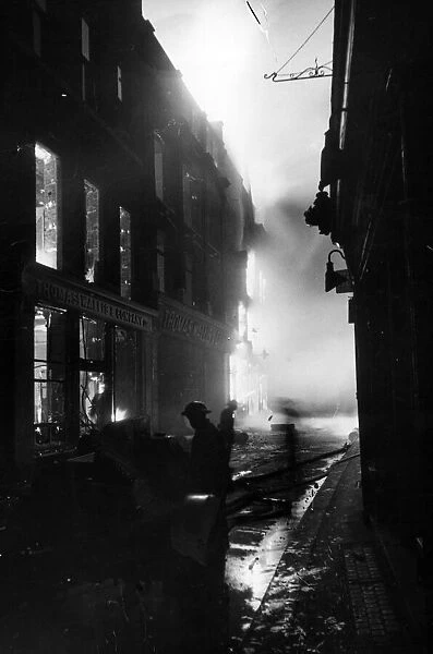 Fires blazing in a shopping district of West London following an air raid attack