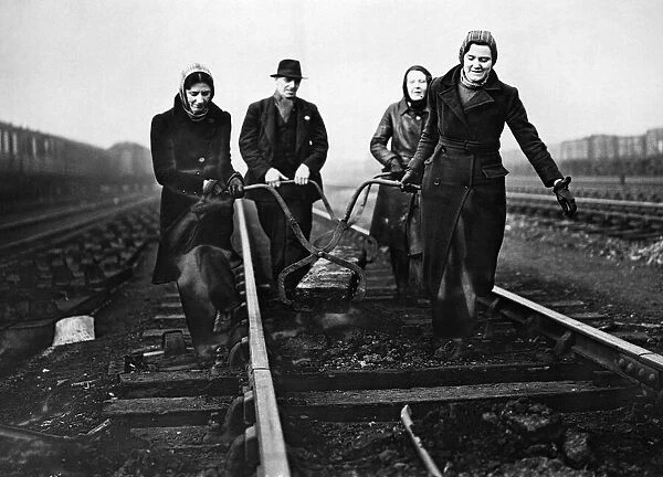 Some of the first women gangers with LNER, busy at work in Sheffield on one of the train