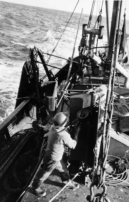 Framed Print : Fisherman aboard British trawler fires an anti-aircraft gun at an enemy plane during WW2