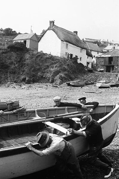 Fisherman launch one of the small fishing boats at Cadgwith. July 1939