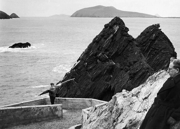 a fisherman makes his way down to the harbour on Ireland