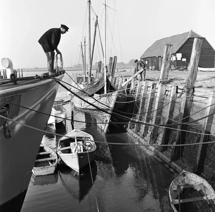 Framed Print : A fisherman mooring his boat at Bosham on the West Sussex Seafront. January 1953