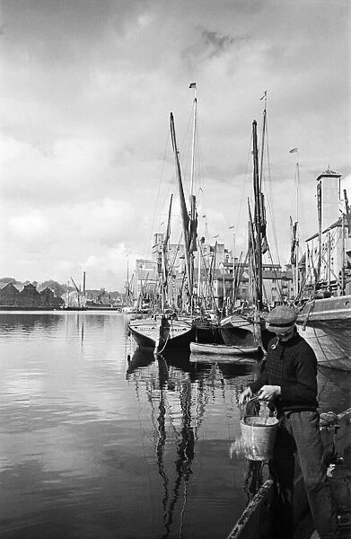 Fisherman at the quayside at Ipswich Docks, on the estuary of the River Orwell, Suffolk