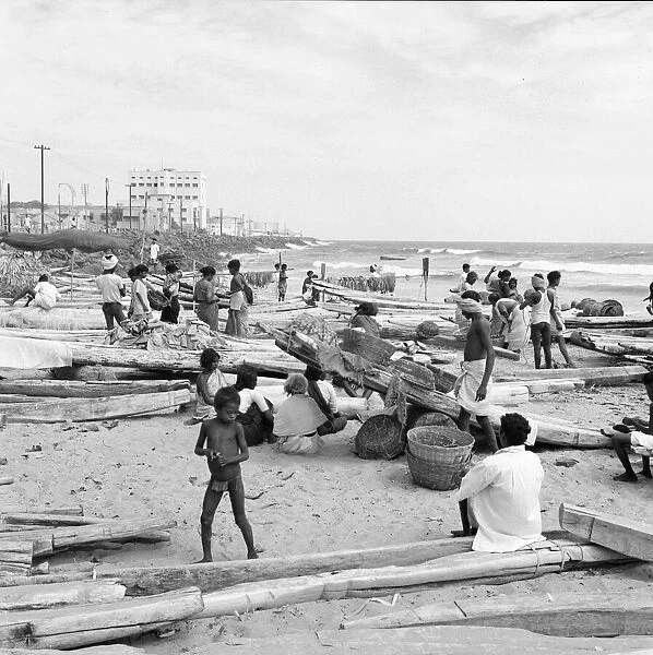Fishermen and beachcombers gather on Chowpatty beach Bombay. February 1961 l