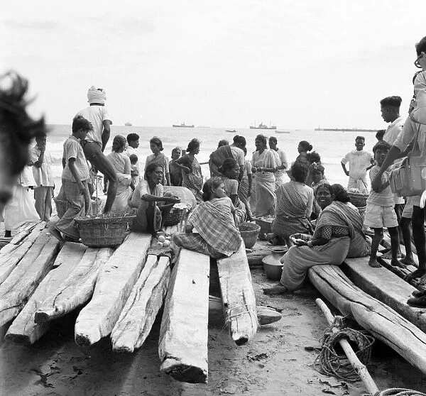 Fishermen and beachcombers gather on Chowpatty beach Bombay. February 1961 l