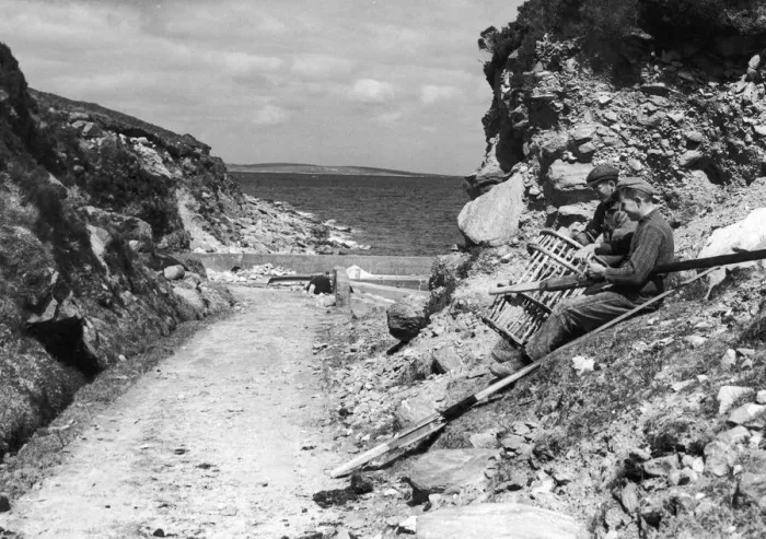 Framed Print : Fishermen seen here on Achill Island County Mayo Ireland repairing their lobster pots