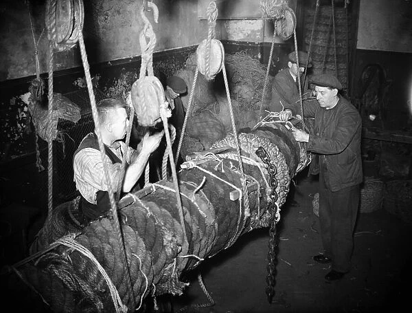 Fishermen seen here making a new fender for the fishing fleet moored in the Cornish
