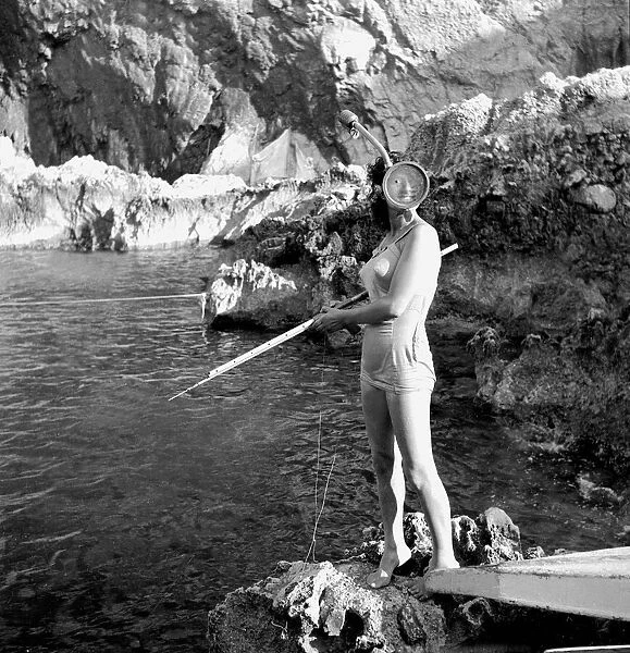 Fishing practice on Capri, Italy woman in old fashioned swimmsuit with snorkel
