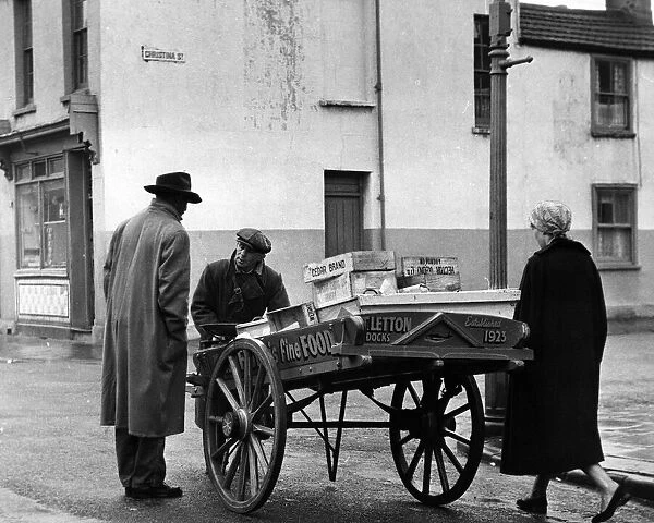 Fishmonger Tommy Letton with his barrow in Butetown, Cardiff. 16th February 1960
