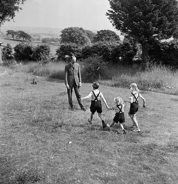 Fitzroy Maclean playing with his children, Jeremy, Susan