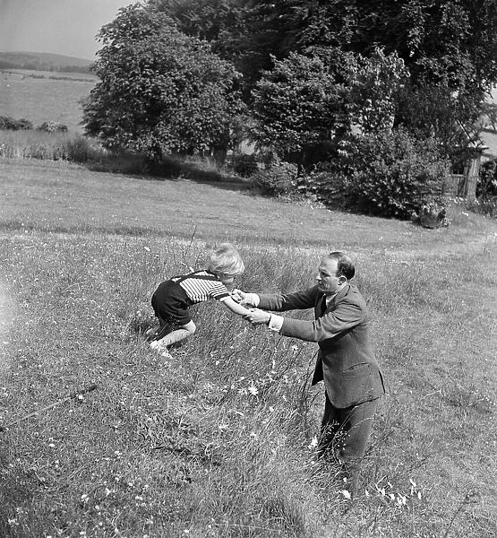 Fitzroy Maclean playing with his son Charles at home at Yealand Conyers, Lancashire. 1949