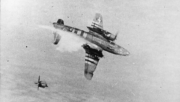 Flames burst from the wings of a B-26 Marauder of the ninth US Air Force