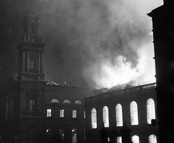 Flames licking around the roof of City Temple, London, following an air raid attack