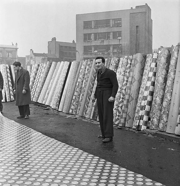 The flea market at Club Row, Bethnal Green, E2 London 1st March 1955 Linoleum salesmen