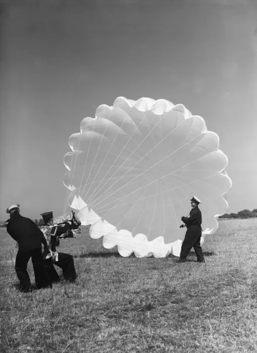 Framed Print : Fleet Air Arm parachute packers seen here testing a parachute at an un-named Royal Naval Framed Print : Fleet Air Arm parachute packers seen here testing a parachute at an un-named Royal Naval