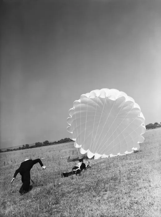 Framed Print : Fleet Air Arm parachute packers seen here testing a parachute at an un-named Royal Naval Framed Print : Fleet Air Arm parachute packers seen here testing a parachute at an un-named Royal Naval