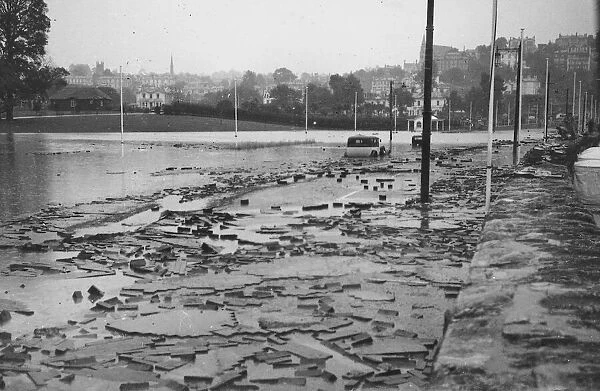 Flooding in Torquay, 4th August 1938. Floating wood blocks on the sea front