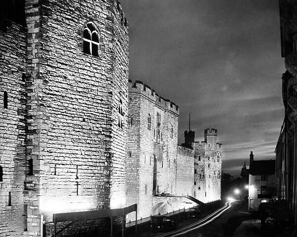 Floodlit Caernarfon castle at night. Gwynedd, Wales. 6th August 1935