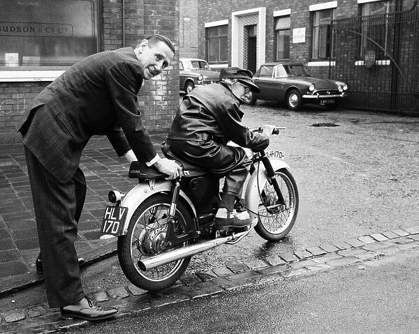 Florrie Ball, 77, is given a push off on her new motorbike by insurance broker Arthur