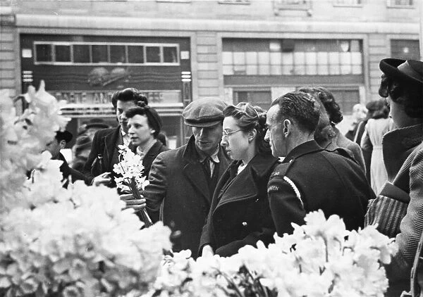 Flowers being bought in The Strand, London. Flowers are cut price at this time