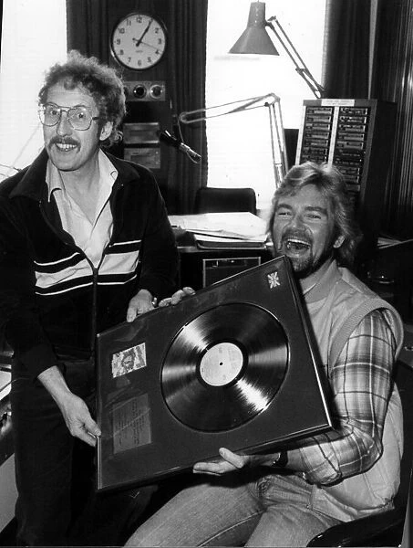 Folk singer Fred Wedlock with DJ Noel Edmonds. With gold record. Circa 1981