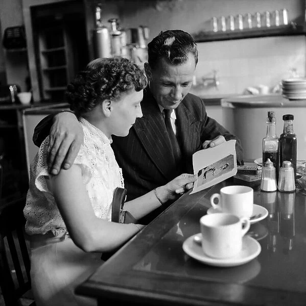Food: Eating out: Couple in cafe in the West End of London. August 1953 D5148-002